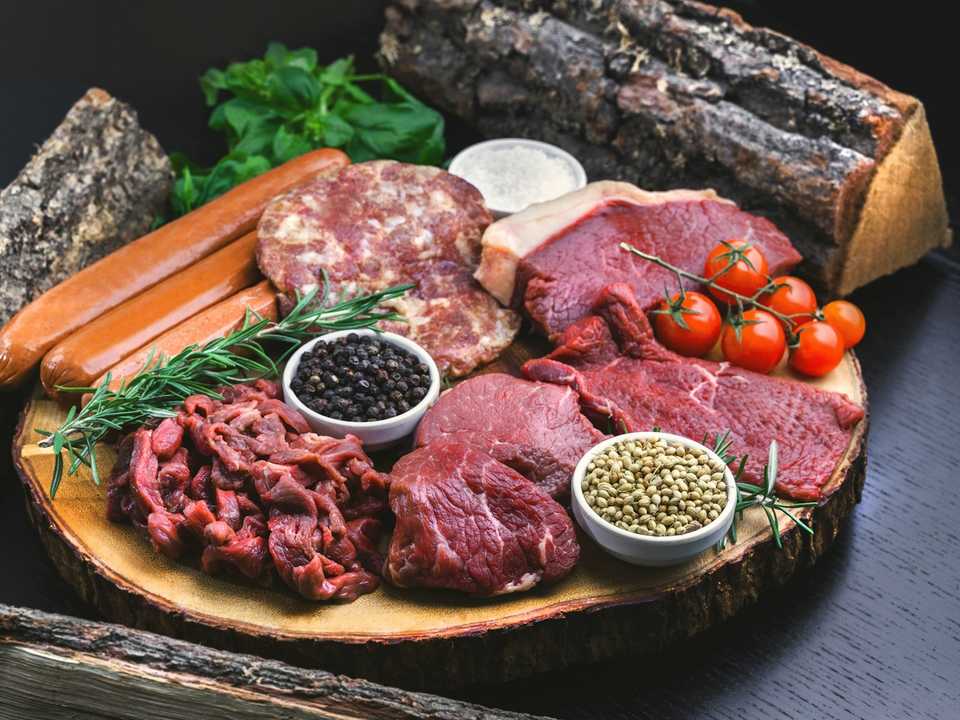 Fresh halal meat cuts displayed at a butcher counter.